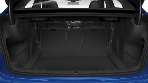 BMW 3 Series, trough-loading system. Close-up of the opened trunk with the rear backseats half folded down.