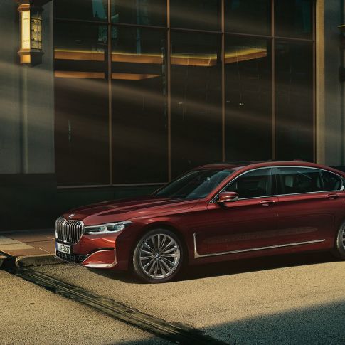 BMW Individual 7 Series Sedan, side view BMW Individual 7 Series Sedan in red in side view in front of urban setting