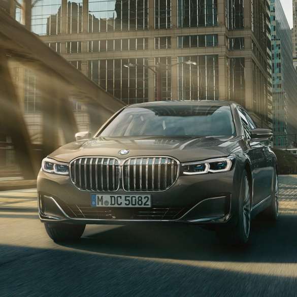 BMW 7 Series Sedan Driving Assistance Systems Driving Assistance Systems: BMW 7 Series Sedan driving in front of urban setting