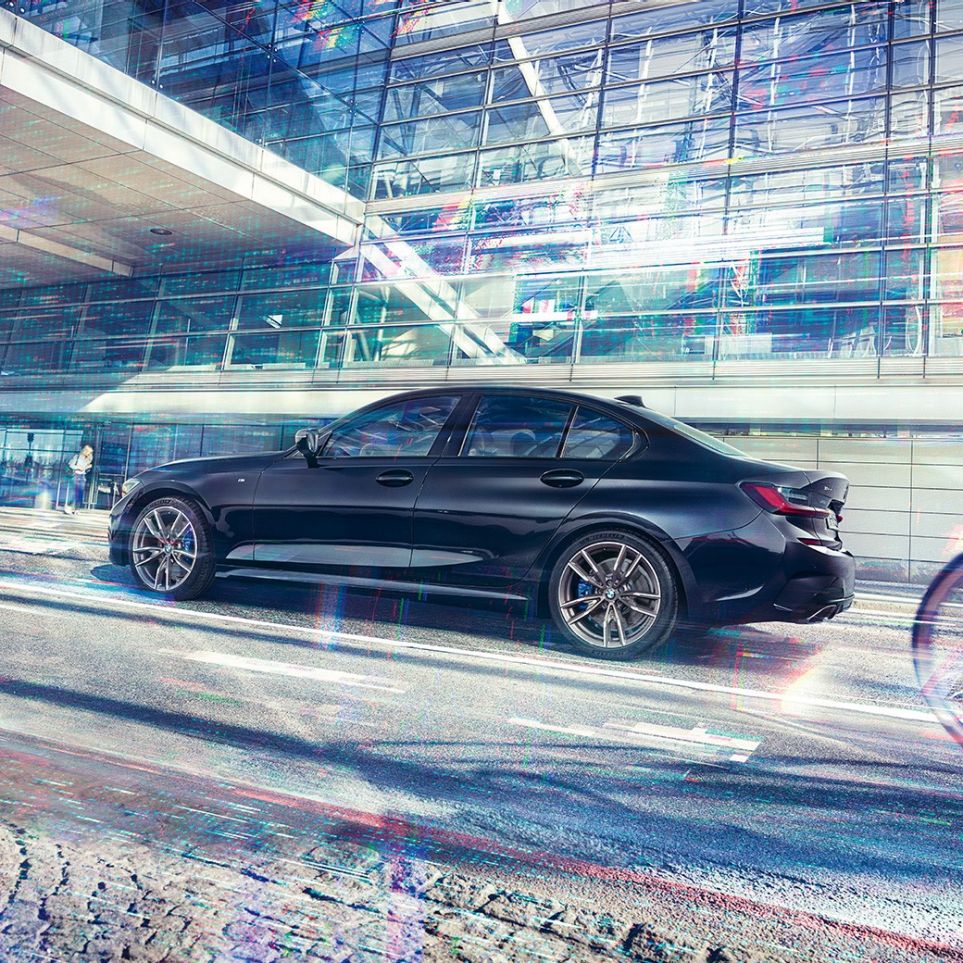 Side view BMW M340i xDrive Sedan BMW M340i xDrive Sedan G20 Sapphire Black metallic side view while driving