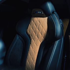 BMW M8 Coupé, M Sport seat. BMW M8 Coupé, M Sport seat with M8 badge and upholstery in full leather 'Merino' Black with contrast Midrand Beige.