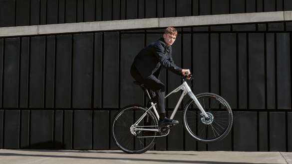 The picture shows a young man doing a dynamic ‘wheelie’ on a BMW Cruise Bike. The picture shows a young man doing a dynamic ‘wheelie’ on a BMW Cruise Bike.