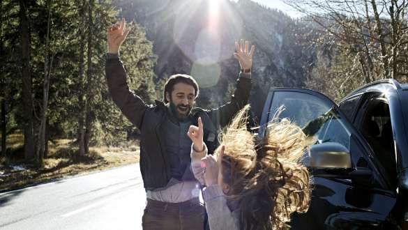 Man and girl in the woods with uplifted hands Man and girl in the woods with uplifted hands