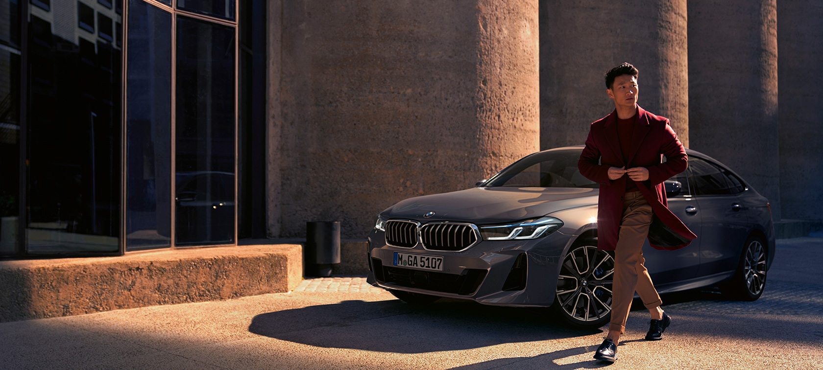BMW 6 Series Bernina Grey man in front of BMW in three-quarter front standing