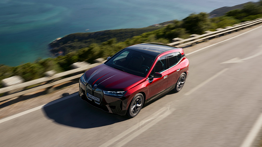 BMW iX i20 electric SUV BMW iX xDrive40 performance BMW iX i20 2021 electric SUV BMW iX xDrive40 Aventurin Red driving on a street performance