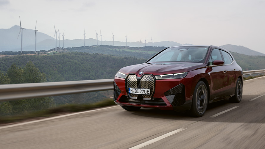 BMW iX xDrive40 i20 electric SUV sustainability BMW iX xDrive40 i20 2021 electric SUV driving on coastal road sustainability