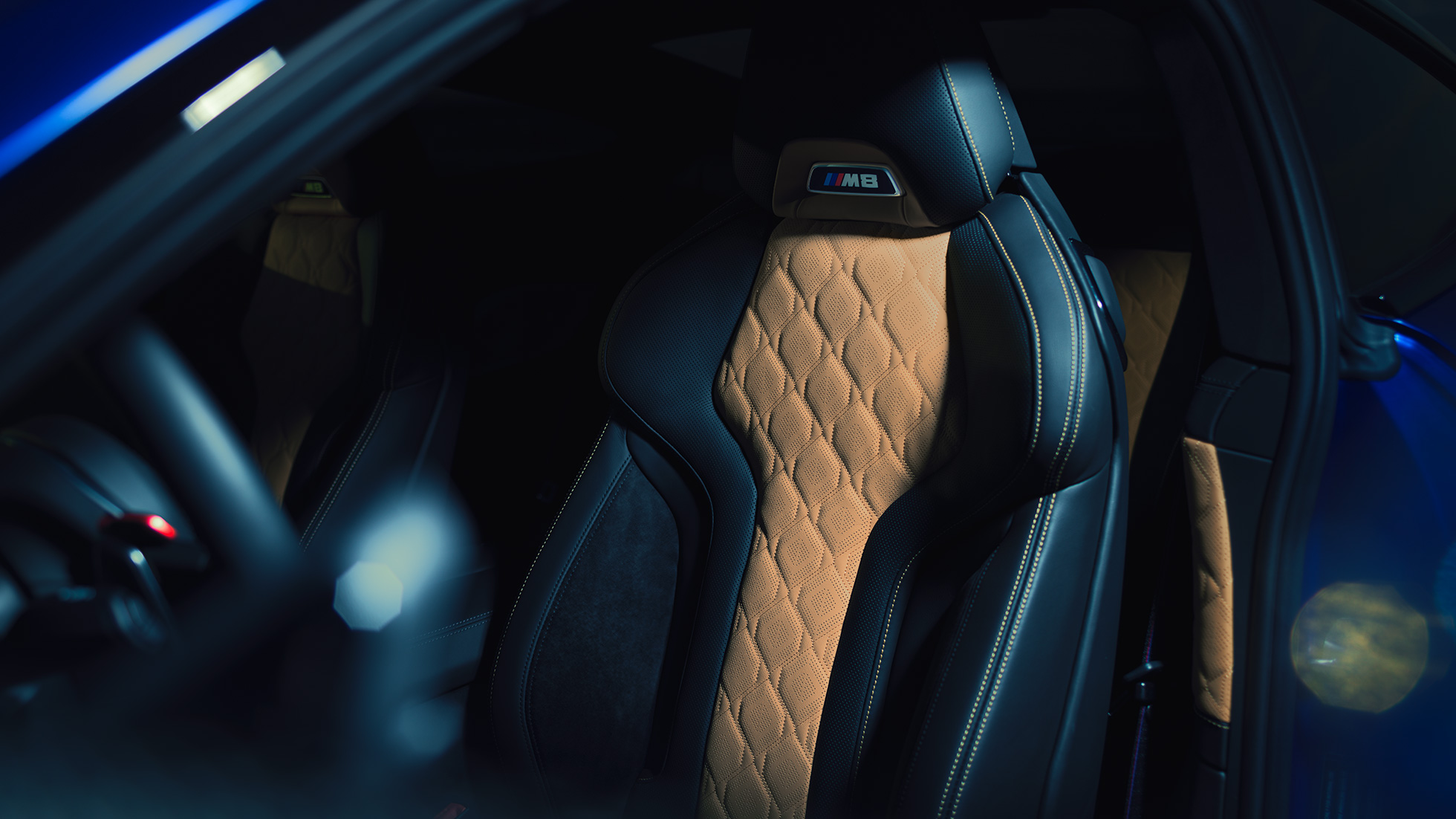 BMW M8 Coupé, M Sport seat. BMW M8 Coupé, M Sport seat with M8 badge and upholstery in full leather 'Merino' Black with contrast Midrand Beige.