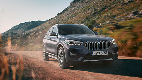 BMW X1 F48 three-quarter front view driving on the street  BMW X Series BMW X1 F48 three-quarter front view driving on the street