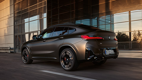 BMW X4 G02 three-quarter rear view driving on the street  BMW X Series BMW X4 G02 three-quarter rear view driving on the street