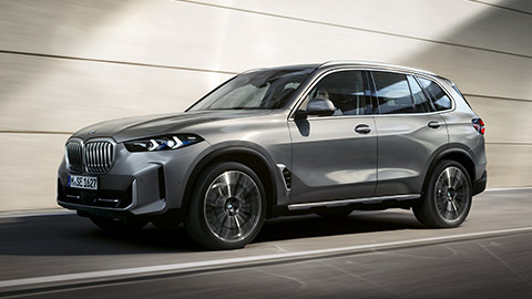 BMW X5 G05 three-quarter side view driving on the street BMW X Series BMW X5 G05 three-quarter side view driving on the street