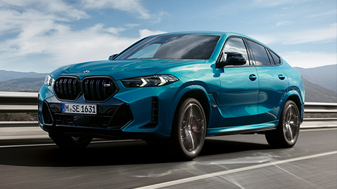 BMW X6 G06 three-quarter side view standing with model BMW X Series BMW X6 G06 three-quarter side view standing with model