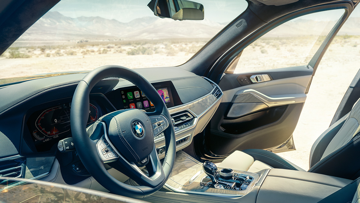 BMW X7 interior BMW X7 interior: view from the outside into the first row of seats with a view of the steering wheel, instrument cluster and leather seats