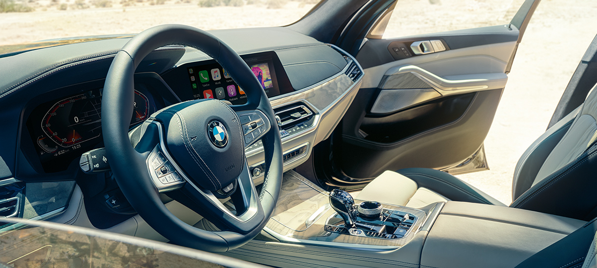 BMW X7 interior BMW X7 interior: view from the outside into the first row of seats with a view of the steering wheel, instrument cluster and leather seats