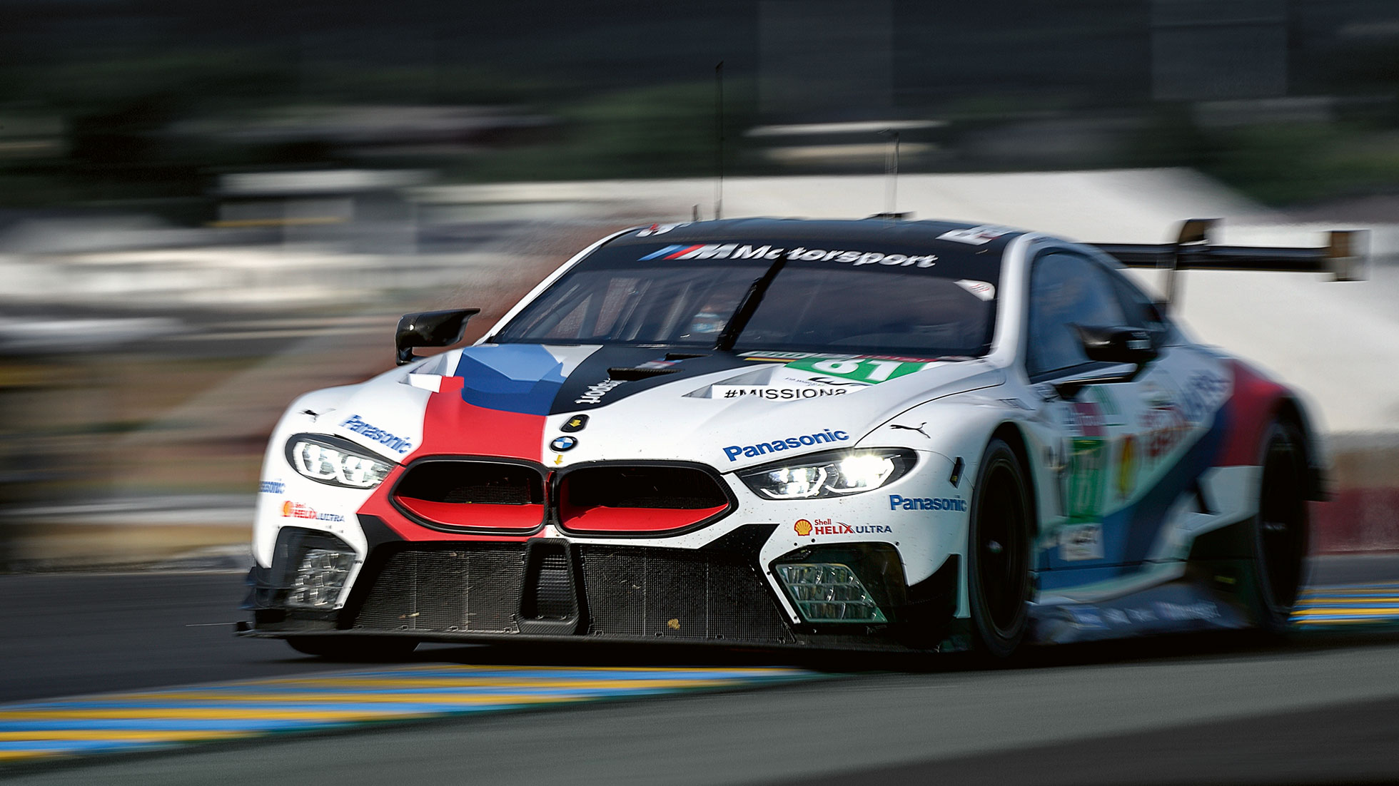 The picture shows the front of a BMW race car. The picture shows the front of a BMW race car.