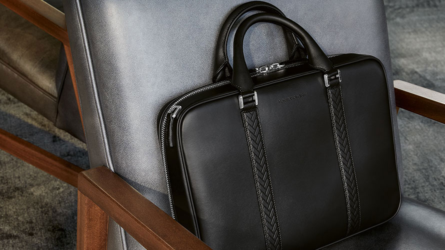 The picture shows the Montblanc for BMW Document Bag lying on a chair.