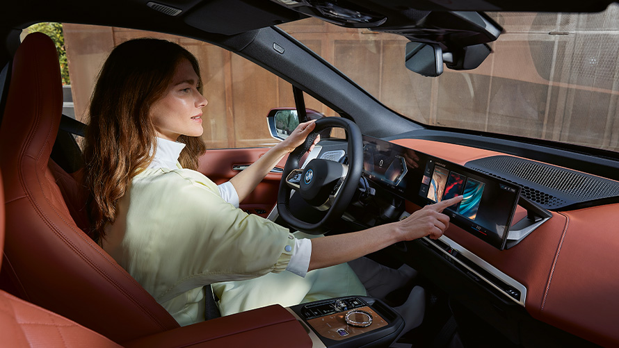 Woman in driver's seat BMW iX My Modes